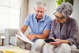Elderly couple looking over finance papers