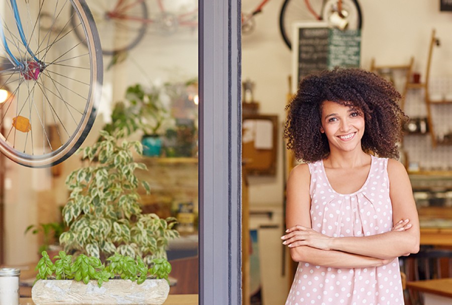 Smiling woman with bike store small business