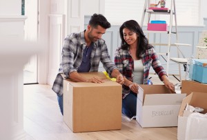 Smiling couple unpacking in their new home