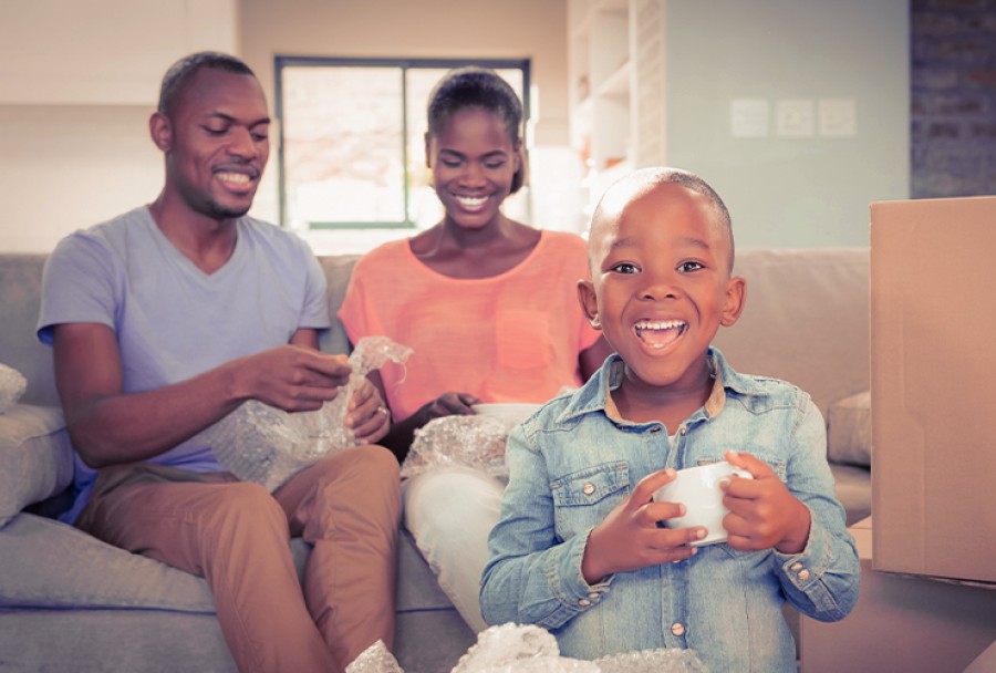 Smiling family unpacking in new home