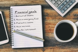 A notepad listing general finance goals