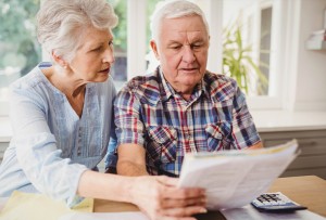 Elderly couple looking over finance papers