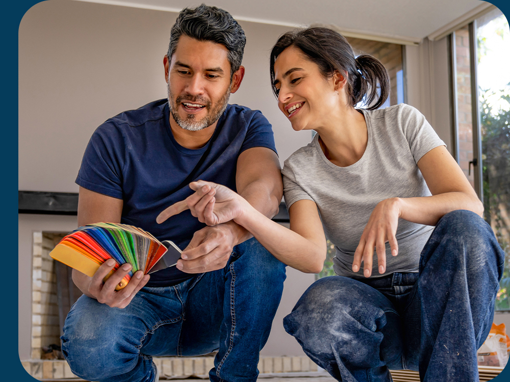 smiling couple looking at new home